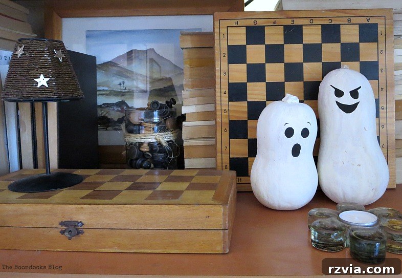 The painted gourds, adding natural elements to the Halloween Wall Unit Decor.