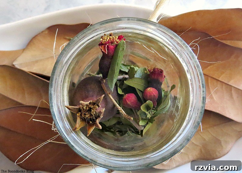 Jar with red dried flowers, adding a subtle splash of color to the Halloween decor.