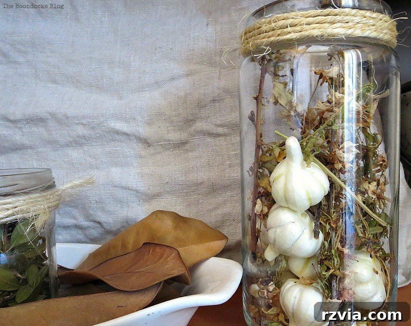 A candy jar full of Autumn elements, a gentle yet potentially ghoulish addition to Halloween decor.