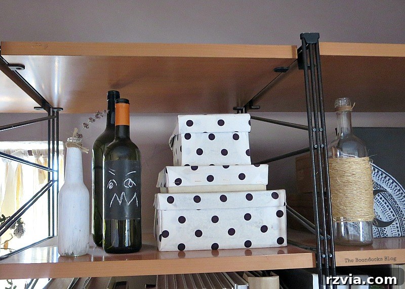 Chalkboard painted bottles, adding versatile and customizable height to the Halloween decor.
