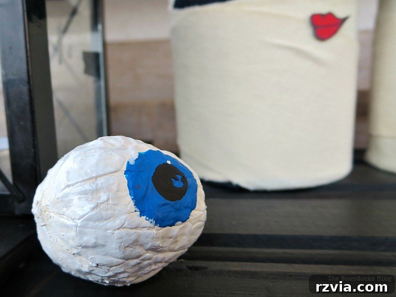 Walnut painted to look like a blue eyeball, mystical Halloween decor