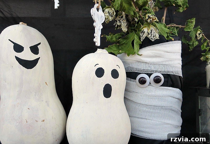 Painted gourds with white bodies and black faces for simple Halloween decor