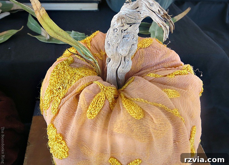 Crafting the Paranoid Pumpkin Man 8 A pumpkin crafted from a scarf and stuffed with toilet paper, part of the fall vignette in 'The Paranoid Man Pumpkin Craft,' from www.theboondocksblog.com