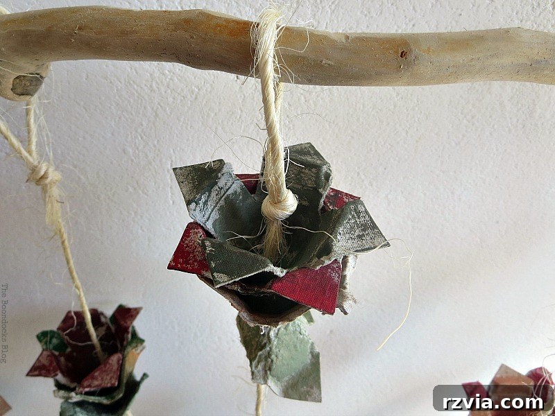 Detailed close-up of an individual egg carton flower, showing how twisted layers of painted cardboard cups mimic flower petals.
