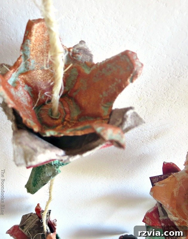 Close-up view of the intricate layers inside a copper-painted egg carton flower, highlighting its texture and unique shape.