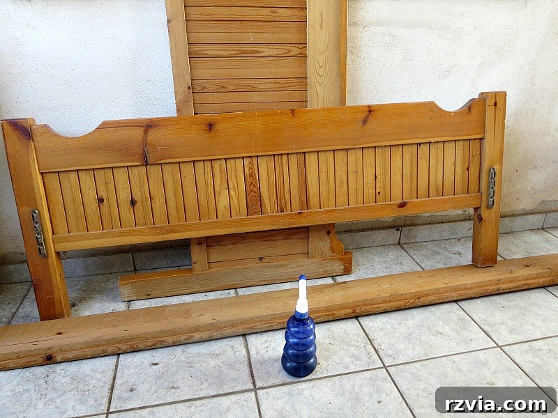 Before photo of an old wooden bed frame with orange varnish, awaiting a DIY makeover. Learn how to transform your furniture at theboondocksblog.com