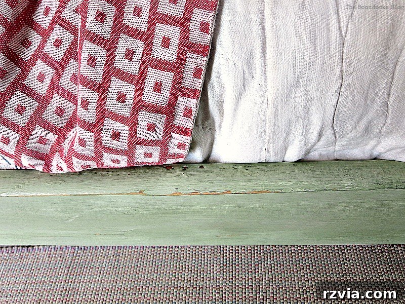 Distressed detail on the side rail of the bed frame, highlighting the vintage, aged effect achieved through careful sanding.