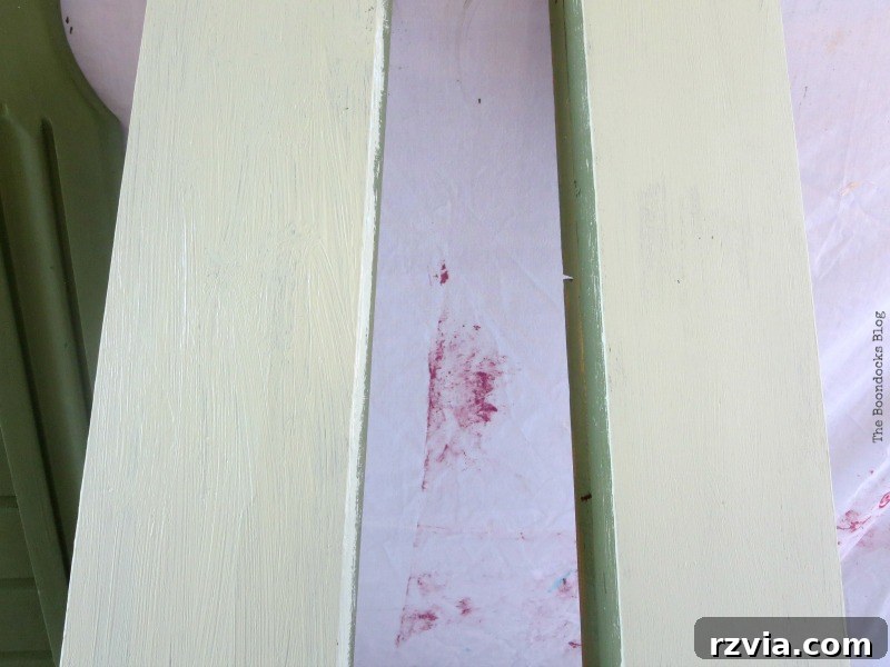 Third coat of paint applied to the bed frame, showing the mix of 'Enchanted' with white acrylic paint. No prior sanding required for this chalky finish paint.