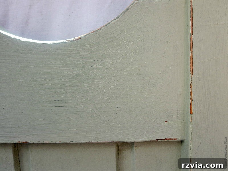 Detailed shot of the distressed areas on the bed frame, showcasing the lighter green tones revealed beneath the topcoat for added depth.