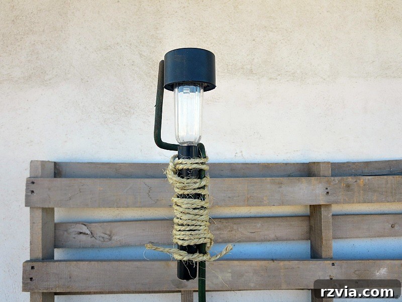 Securing the solar light onto the coffee roaster with twine