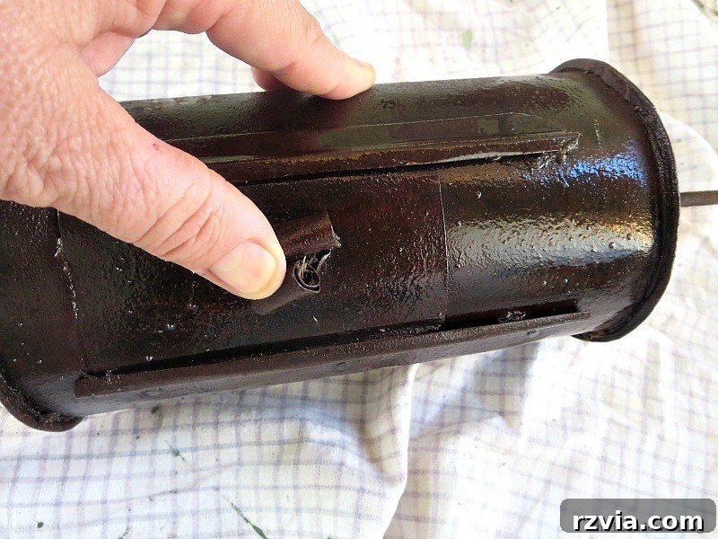 Attempting to open the stuck door on the Vintage Coffee Roaster