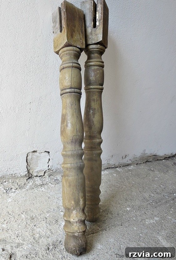 Upcycled Elegance: Crafting a Pallet and Salvaged Wood Table 3 Close-up of the rescued table legs before restoration, highlighting their cracks and worn appearance. These legs are the core of our DIY pallet table project. www.theboondocksblog.com