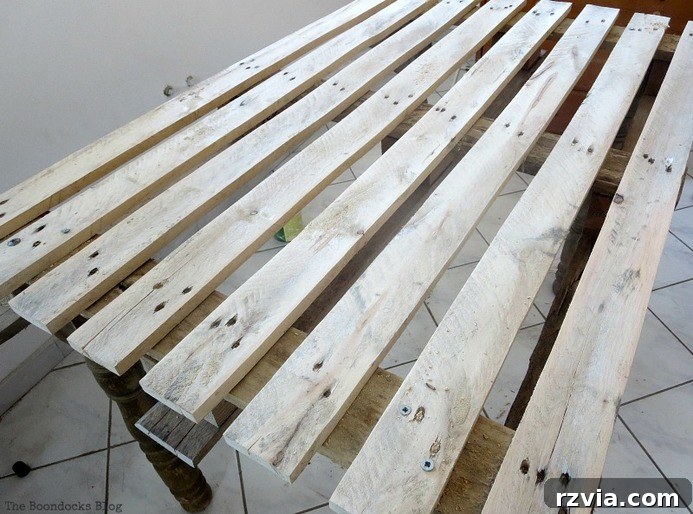 Upcycled Elegance: Crafting a Pallet and Salvaged Wood Table 4 The wooden pallet after thorough sanding, revealing its natural grain and ready to be transformed into the top of our DIY pallet table. www.theboondocksblog.com