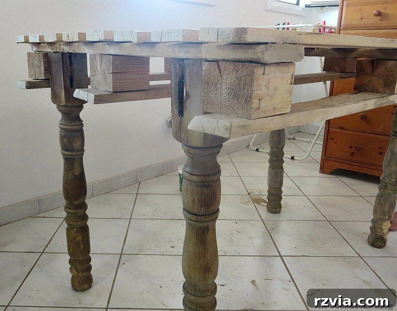 Upcycled Elegance: Crafting a Pallet and Salvaged Wood Table 5 The initial attempt at attaching the table legs, resulting in a wobbly structure that led to the table being affectionately called 'the drunken table.' www.theboondocksblog.com