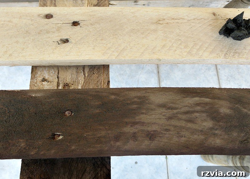 Upcycled Elegance: Crafting a Pallet and Salvaged Wood Table 9 Applying the homemade natural wood stain solution to the pallet wood, showing the initial color change and the process of staining. www.theboondocksblog.com