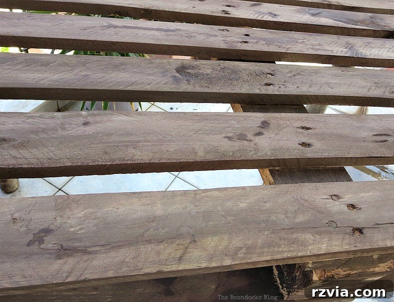 Upcycled Elegance: Crafting a Pallet and Salvaged Wood Table 10 The pallet wood after one coat of the natural wood stain solution, demonstrating the initial depth of color and rustic charm achieved. www.theboondocksblog.com