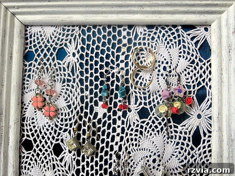 DIY Earring Storage Made Simple 12 An overhead view of the earring organizer, emphasizing the rustic frame and the neatly hung earrings.