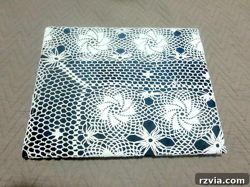 DIY Earring Storage Made Simple 7 The cardboard backing being covered with the blue satin blouse fabric, topped with a white doily for the earring holes.