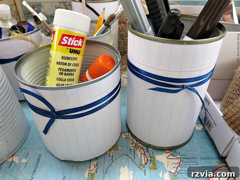 What Stories Does the Vintage Suitcase Tell 12 Decorated tin cans used for organized craft supply storage inside a vintage suitcase
