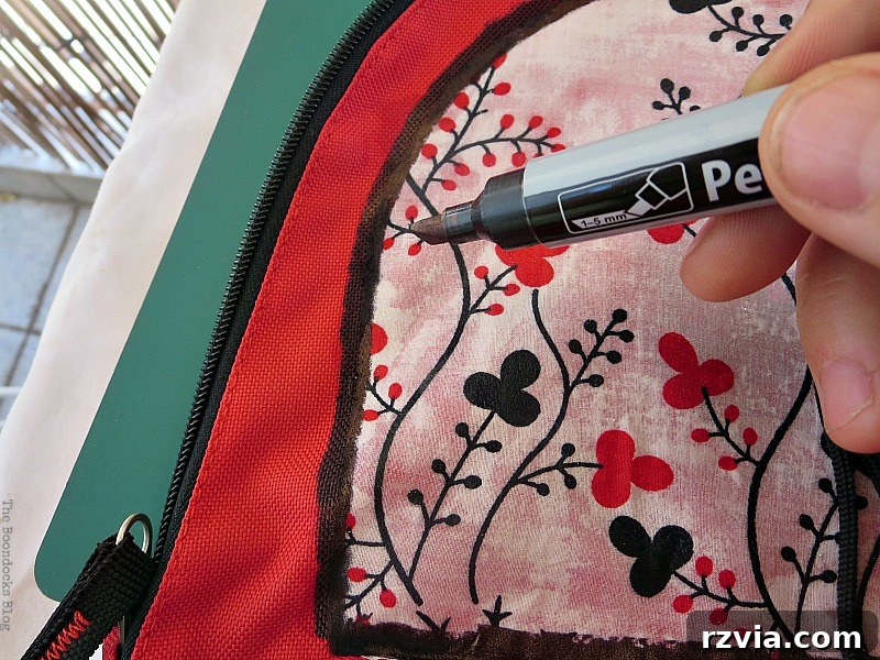 From Fabric Scraps to Adventure Packs 12 Creating a defined border on the top fabric section of the backpack using a permanent marker.