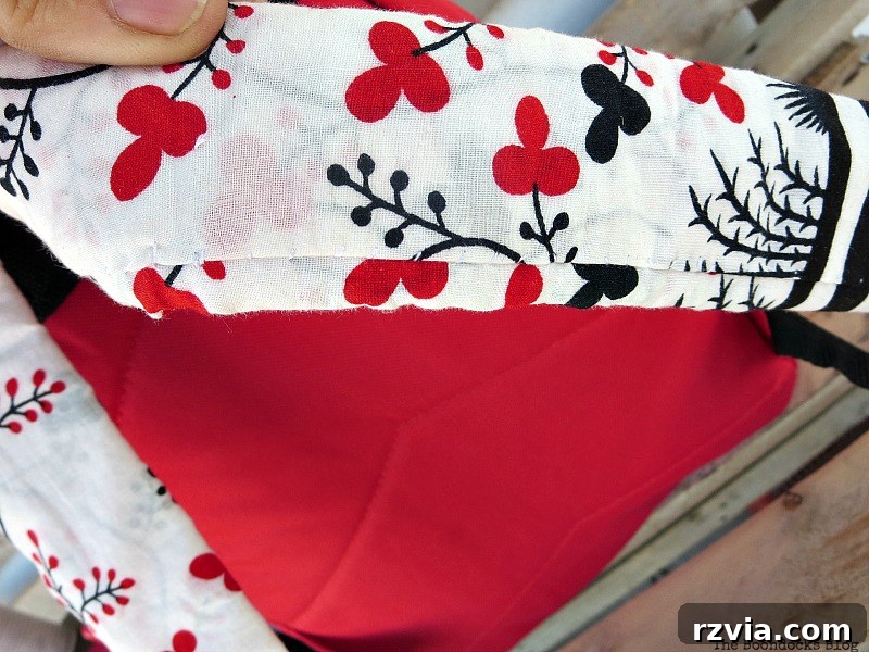 From Fabric Scraps to Adventure Packs 14 Sewing fabric onto the backpack straps for a cohesive and comfortable finish.