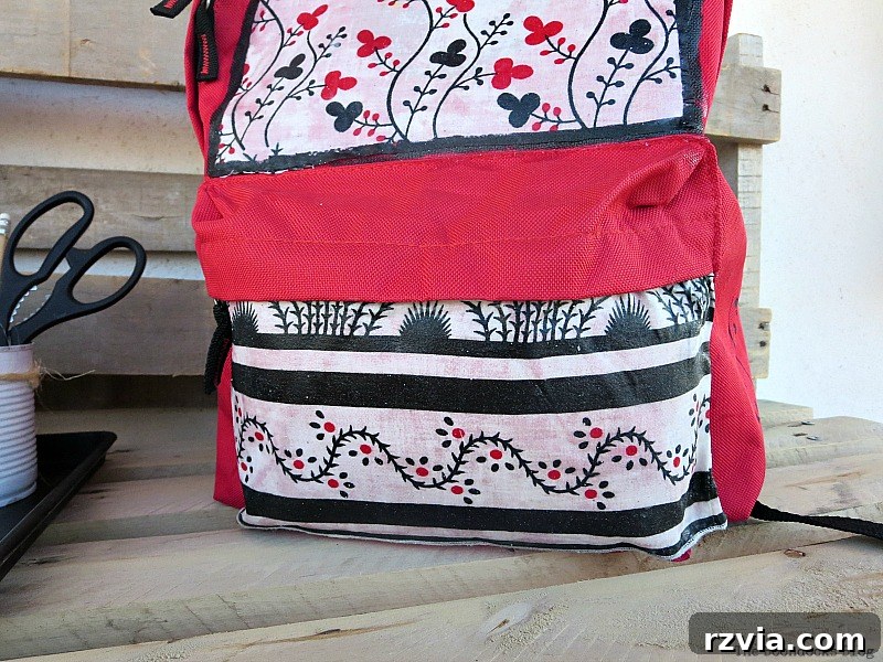 From Fabric Scraps to Adventure Packs 20 Front view of the backpack's pocket, now stylishly covered with fabric.