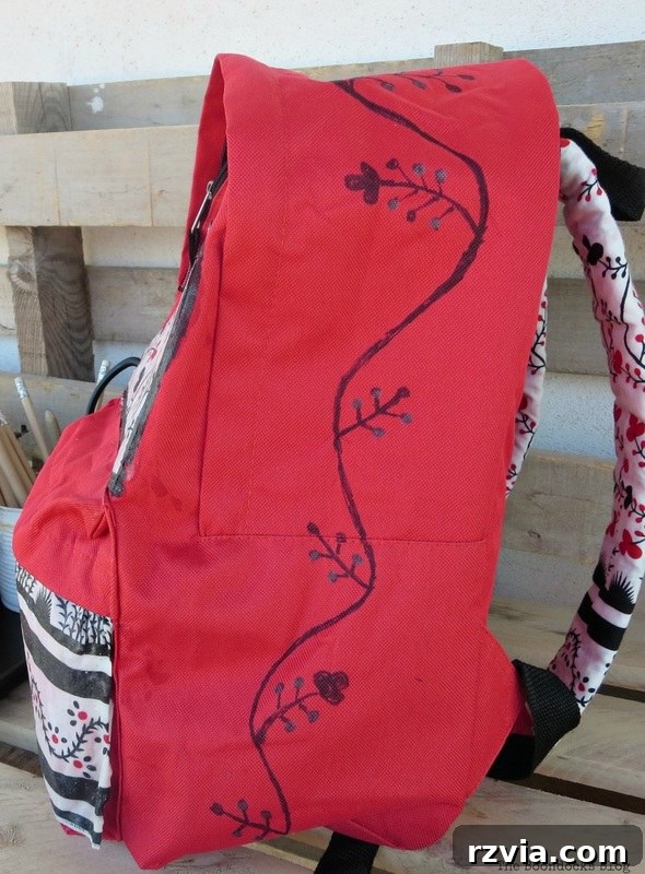 From Fabric Scraps to Adventure Packs 21 Side view of the backpack, highlighting the flower design enhanced with metallic paint for added interest.