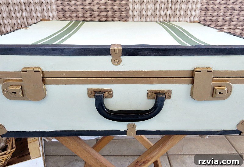 Breathing New Life into Old Luggage 15 A front view of the suitcase, illustrating how the gold clasps are not perfectly symmetrical with the handle, influencing design decisions.