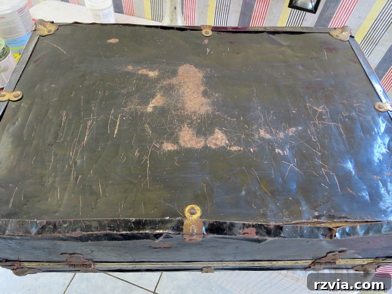 Breathing New Life into Old Luggage 3 Top view of the severely rusted and scratched vintage suitcase before restoration, highlighting its "before" condition.
