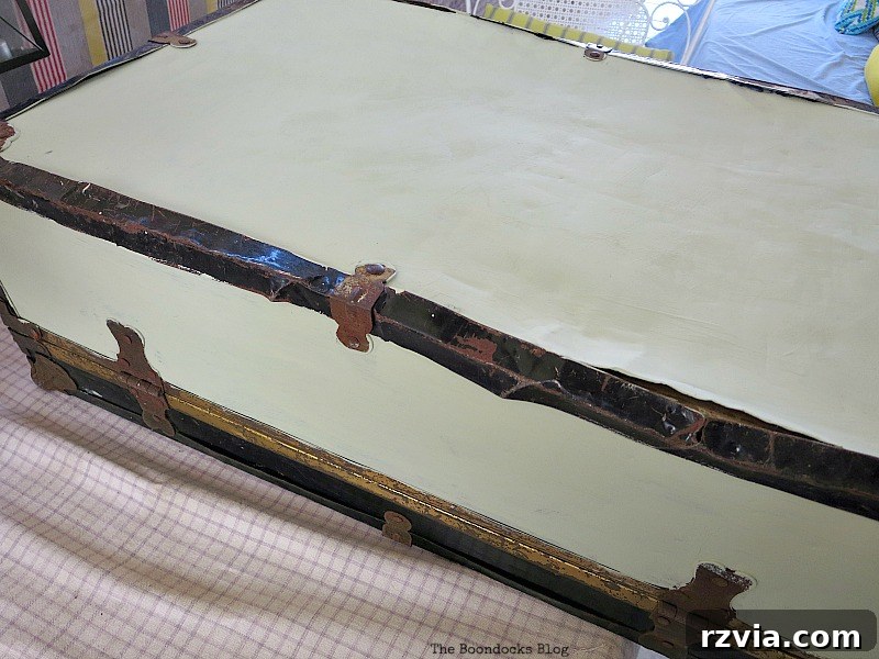 Breathing New Life into Old Luggage 4 Applying a custom-mixed soft olive green chalk paint to the sides, top, and bottom surfaces of the vintage suitcase.