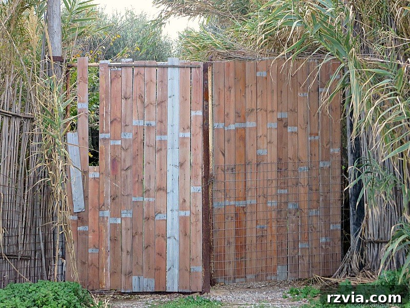Thoughtfully reconstructed wooden gate, blending old charm with new stability in a Greek setting, from www.theboondocksblog.com.