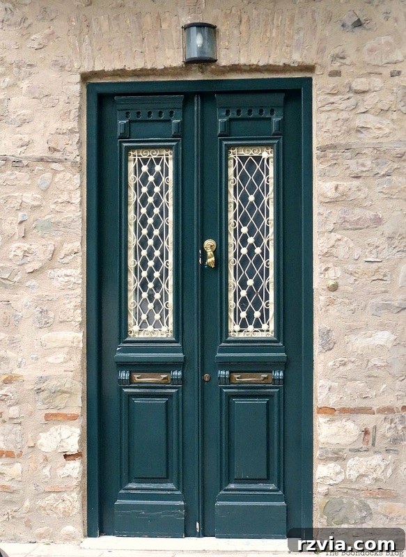 Charming green door with crisp white trim, a classic residential entrance in Greece, highlighted in www.theboondocksblog.com's door photography.