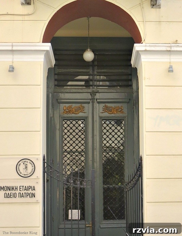 Historic door framed by elegant arches and secured by a sturdy gate, showcasing traditional Greek architectural elements on www.theboondocksblog.com.