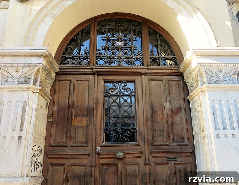 Rustic wooden church door, a symbol of faith and tradition in Greece, part of www.theboondocksblog.com's photo essay.