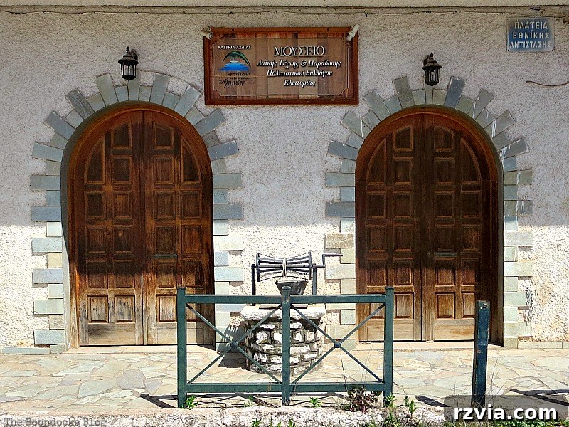 Imposing twin wooden museum doors, suggesting historical significance and grand interiors in Greece, featured on www.theboondocksblog.com.