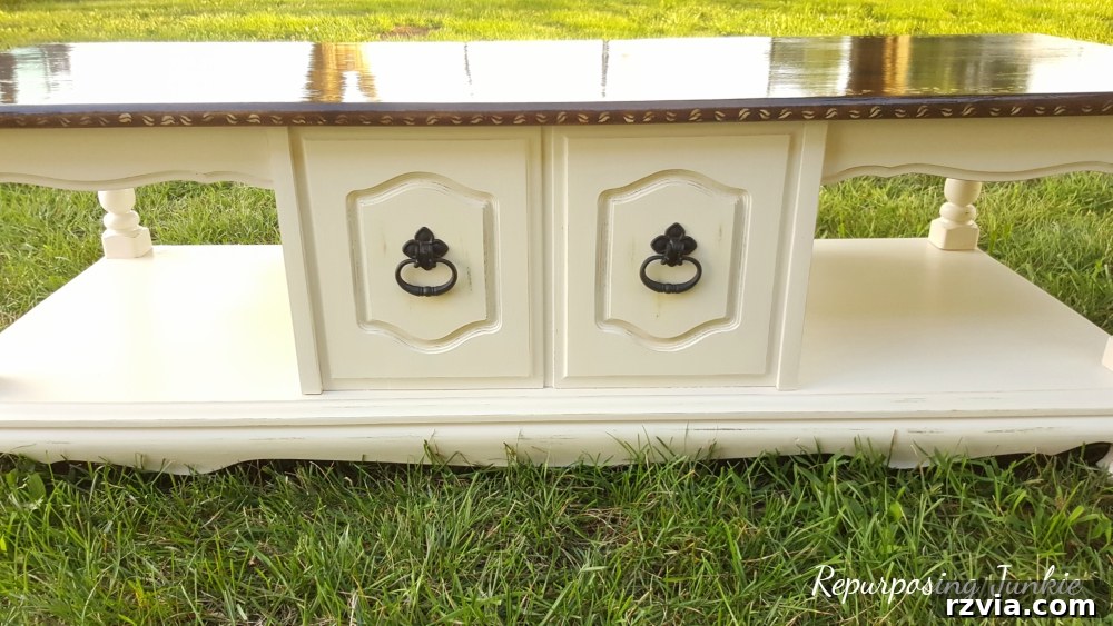 From Curb to Chic: Coffee Table's Gorgeous New Look 5 Painting the lower half of the coffee table, demonstrating the initial stages of a stunning DIY transformation.
