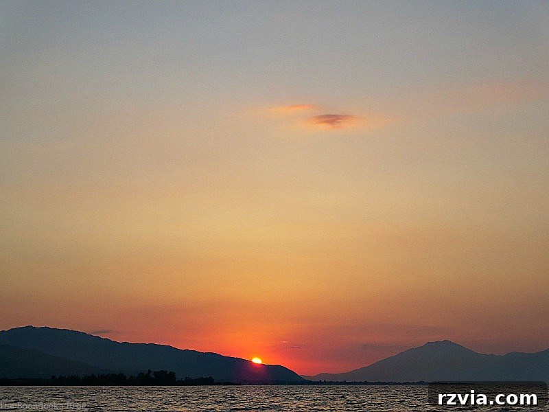 A far view of the captivating sunset over the vast expanse of the sea