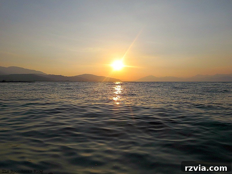 The sinking sun casting vibrant colors across the horizon
