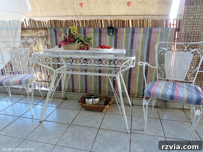 A full view of the outdoor table and two chairs, inviting guests to enjoy the balcony's ambiance. A Table and Two Chairs, Part 1 www.theboondocksblog.com