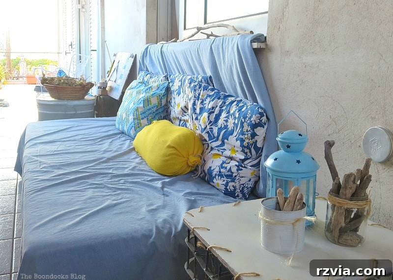A comfortable daybed created from a folding cot, adorned with a duvet, inviting relaxation and showcasing smart, budget-friendly design. A Day Bed, Part 1 www.theboondocksblog.com