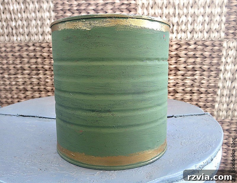 Applying DecoArt Chalky Finish paint in Enchanted to a tin can, showing the transformation process for a DIY repurposed vase.