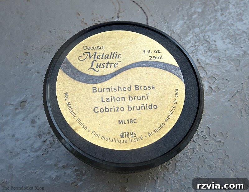 Close-up of DecoArt Metallic Lustre in brass finish applied to the tin can, highlighting decorative details for a repurposed project.