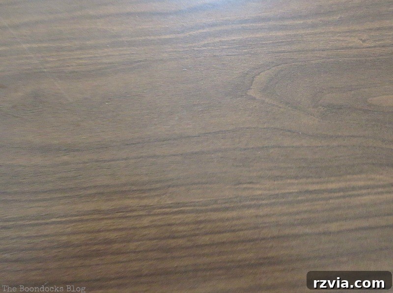 Close-up of the laminate tabletop before makeover, highlighting imperfections and the need for a fresh coat of paint. This table will soon become a beautiful Greek Beach Table, a testament to upcycling for the Int'l Bloggers Club Challenge, by theboodocksblog.com