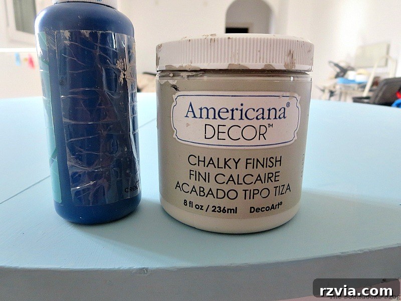 Mixing acrylic blue into chalk paint to create a custom Greek-inspired shade for the tabletop, a creative step in the Greek Beach Table makeover for the Int'l Bloggers Club Challenge, by theboodocksblog.com