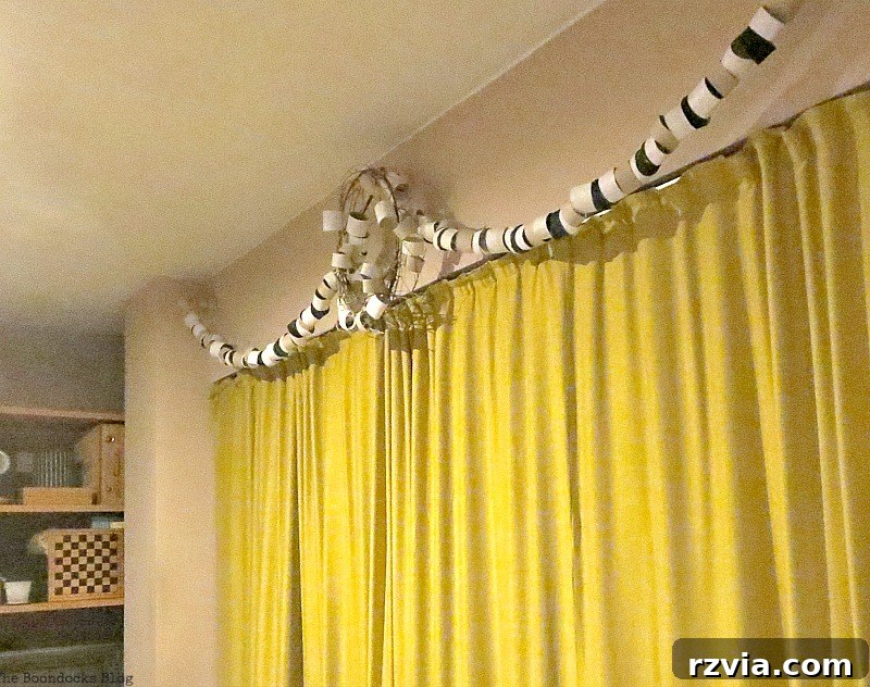Nighttime photograph of the paper roll garland and wreath installation, providing a view of the sliding doors' length and how the decor appears under interior lighting, creating a cozy evening atmosphere.