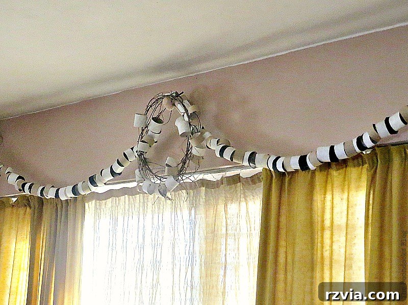 Daylight view of the paper roll garland and wreath, emphasizing the intricate details of the upcycled decor while also revealing the wall color, which appears dramatically different under natural sunlight, showcasing another home improvement project.