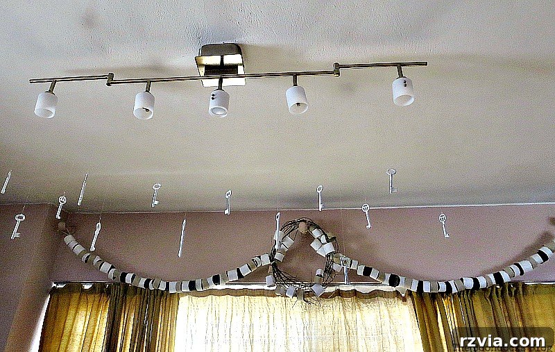 The comprehensive installation showcasing all three previously unsightly brackets now elegantly covered by the cohesive paper roll garland and the central rustic wreath. This image captures the full, harmonious transformation of the space.