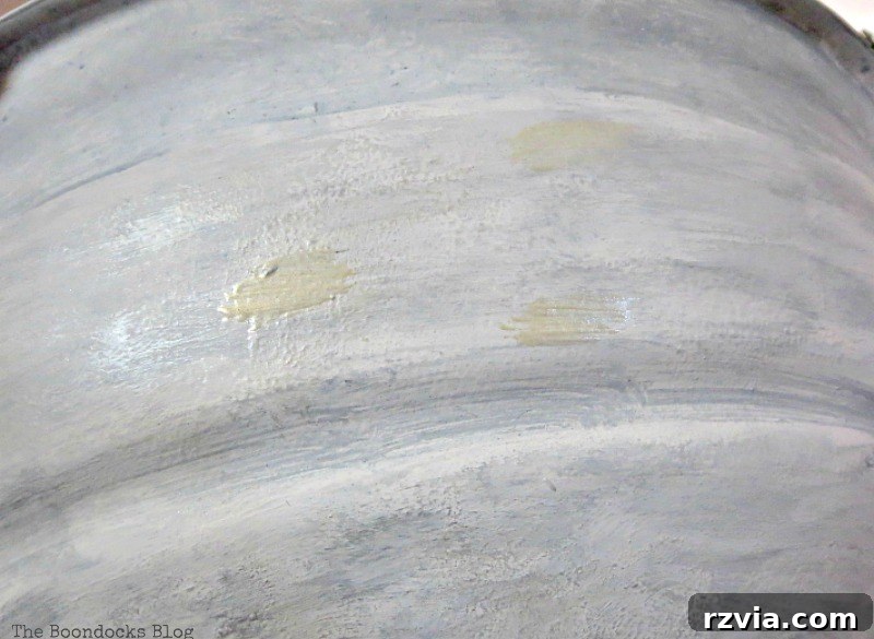 Adding highlights with grey paint to the grill's surface, then wiping for a distressed look