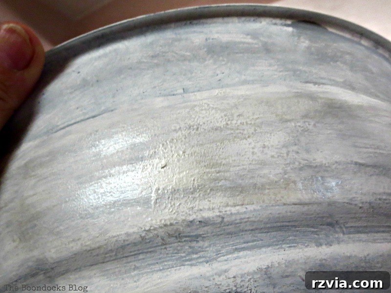 Applying protective wax to the painted grill, completing the surface transformation