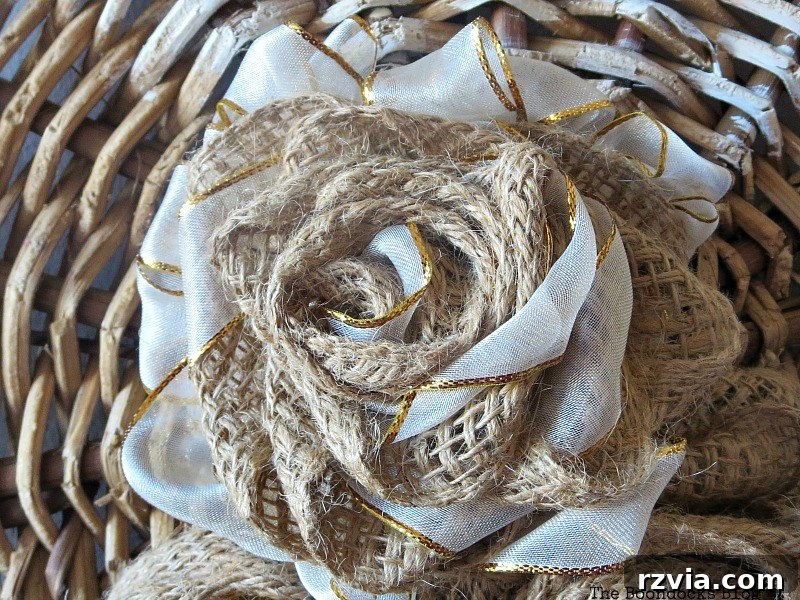 Shabby Chic Wicker Basket Revival 13 A decorative flower crafted from burlap and white and gold ribbon.